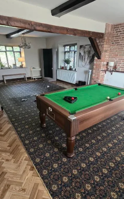 Lounge with old patterned blue carpet, before the job