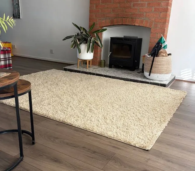 Living room with wood-effect flooring and a brick fireplace