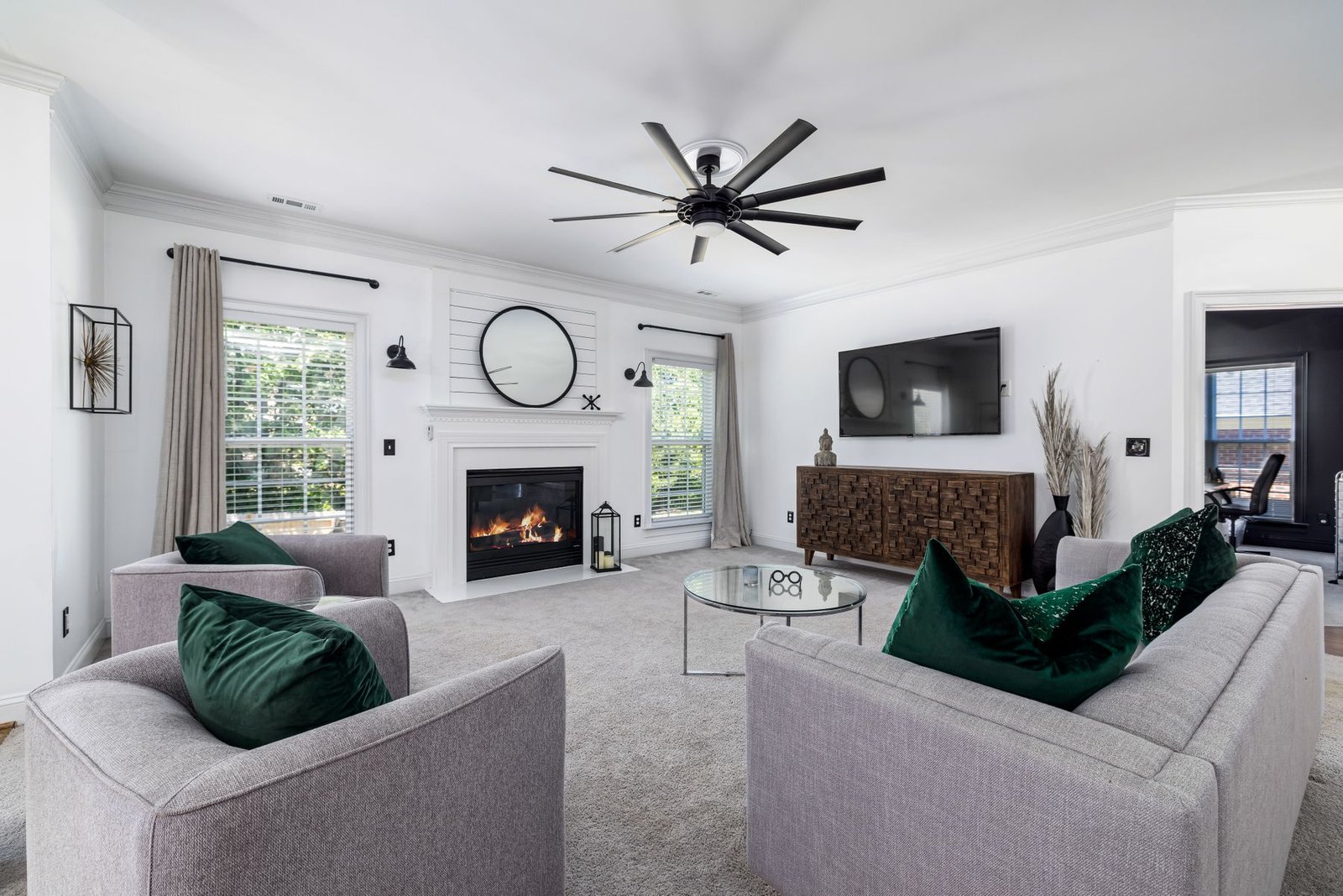 A furnished living room with a soft neutral carpet